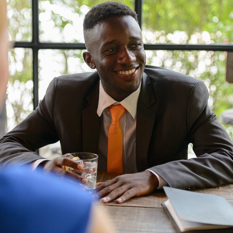 Portrait of young African businessman and young businesswoman with red hair together